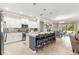 Open kitchen with a spacious island, seating, white cabinetry, and stainless steel appliances at 9203 Sw 97Th Cir, Ocala, FL 34481