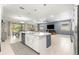 Open concept living area with blue accent wall, kitchen island, and view of the outdoor dining area at 9203 Sw 97Th Cir, Ocala, FL 34481