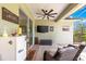 Inviting covered patio featuring a ceiling fan, television, and comfortable seating area at 9203 Sw 97Th Cir, Ocala, FL 34481