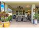 Covered patio featuring outdoor seating, plants, and a ceiling fan at 9203 Sw 97Th Cir, Ocala, FL 34481