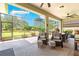 Relaxing screened-in patio with comfortable seating and a view of the beautiful backyard at 9203 Sw 97Th Cir, Ocala, FL 34481