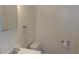 Bright bathroom featuring a toilet, sink, mirror, and towel rack at 9960 Sw 103Rd Ln, Ocala, FL 34481