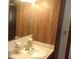 Bathroom sink with marble countertop and wooden cabinets at 9960 Sw 103Rd Ln, Ocala, FL 34481