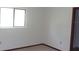 Simple bedroom with carpet flooring, a window, and a door leading to another room at 9960 Sw 103Rd Ln, Ocala, FL 34481