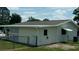 Exterior view of home showing backyard, fence, and awning for shade at 9960 Sw 103Rd Ln, Ocala, FL 34481