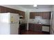 Functional kitchen with wood cabinets and standard appliances, offering a practical cooking space at 9960 Sw 103Rd Ln, Ocala, FL 34481