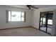Neutral living room showcasing carpet flooring, a ceiling fan, and access to the lanai at 9960 Sw 103Rd Ln, Ocala, FL 34481