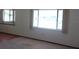 Spacious living room with ample natural light and a combination of carpet and wood flooring at 9960 Sw 103Rd Ln, Ocala, FL 34481