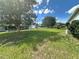 Lush backyard with mature trees, green grass, and views of the surrounding neighborhood at 10080 Sw 97Th Ct, Ocala, FL 34481