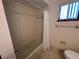 Bathroom with a bathtub and shower with white shower curtain and a window at 10080 Sw 97Th Ct, Ocala, FL 34481