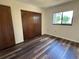 Bedroom with dark wood floor, large closet, and natural light from the window at 10080 Sw 97Th Ct, Ocala, FL 34481
