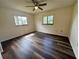 Bedroom featuring two windows that bring in natural light, complemented by a modern ceiling fan at 10080 Sw 97Th Ct, Ocala, FL 34481