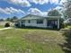 Charming home featuring a covered porch and well-manicured lawn, set in a serene neighborhood at 10080 Sw 97Th Ct, Ocala, FL 34481