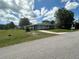 Inviting exterior of a well-maintained home with a sprawling front lawn and a long driveway at 10080 Sw 97Th Ct, Ocala, FL 34481