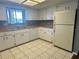 Bright kitchen with stainless steel sink, white cabinetry and tiled floor at 10080 Sw 97Th Ct, Ocala, FL 34481