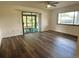 Open-concept Living Room that features sliding glass doors to the lanai and new wood flooring at 10080 Sw 97Th Ct, Ocala, FL 34481