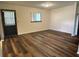 Well-lit Living Room with new wood flooring and natural light from the exterior window at 10080 Sw 97Th Ct, Ocala, FL 34481