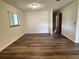 Living room with new vinyl floor, neutral wall color, and view of the hallway at 10080 Sw 97Th Ct, Ocala, FL 34481