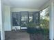 Screened-in patio with view to the backyard, room for seating and gardening at 10080 Sw 97Th Ct, Ocala, FL 34481