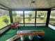 Relaxing porch with screened windows offering views of the beautifully landscaped backyard and a generator for backup power at 10080 Sw 97Th Ct, Ocala, FL 34481