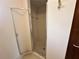 Bathroom shower with glass doors and tile flooring and walls at 10080 Sw 97Th Ct, Ocala, FL 34481