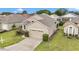 Charming home with a well-manicured lawn, lush landscaping, and a spacious driveway in a friendly neighborhood at 11062 Sw 73Rd Ct, Ocala, FL 34476
