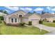 Beautiful home with a meticulously maintained lawn, manicured landscaping, and a driveway in a lovely neighborhood setting at 11062 Sw 73Rd Ct, Ocala, FL 34476