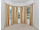 Bedroom features a bay window with neutral carpet and blinds at 11062 Sw 73Rd Ct, Ocala, FL 34476