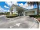 Entrance to the golf club building, featuring white pillars, manicured landscaping, and clear directional signage at 11062 Sw 73Rd Ct, Ocala, FL 34476