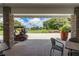 Covered exterior lounge area offering a beautiful golf course view with a golf cart at 11062 Sw 73Rd Ct, Ocala, FL 34476