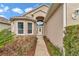 Home's entryway features a tiled walkway, and a leaded glass front door with sidelights and transom window at 11062 Sw 73Rd Ct, Ocala, FL 34476