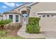 Charming home with a manicured front yard, arched entryway, and attached garage, showcasing inviting curb appeal at 11062 Sw 73Rd Ct, Ocala, FL 34476