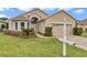 Charming single-story home with a well-maintained lawn, mature landscaping, and neutral stucco exterior at 11062 Sw 73Rd Ct, Ocala, FL 34476