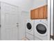 Laundry room features washer, dryer and cabinet storage at 11062 Sw 73Rd Ct, Ocala, FL 34476