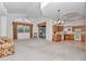 Spacious living area with vaulted ceilings, ceiling fan, and sliding glass door to patio at 11062 Sw 73Rd Ct, Ocala, FL 34476