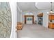 Bright open-concept living room features vaulted ceilings, neutral paint, and sliding glass doors to lanai at 11062 Sw 73Rd Ct, Ocala, FL 34476