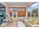 Cozy enclosed lanai with tiled flooring, offering ample seating and natural light at 11062 Sw 73Rd Ct, Ocala, FL 34476