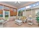 Enclosed patio featuring wicker furniture, tile floor, and views of the backyard at 11062 Sw 73Rd Ct, Ocala, FL 34476