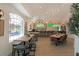 Bright restaurant area featuring modern tables, chairs, bar with multiple televisions, and decorative lighting at 11062 Sw 73Rd Ct, Ocala, FL 34476