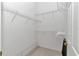 A walk-in closet has white walls, carpet, and a series of adjustable wire shelves for storage at 11062 Sw 73Rd Ct, Ocala, FL 34476