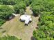 Aerial shot of a property with a charming home surrounded by mature trees at 12080 Se Sunset Harbor Rd, Weirsdale, FL 32195