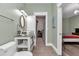 Bathroom featuring a single vanity, oval mirror, toilet, and doorway into a closet at 12080 Se Sunset Harbor Rd, Weirsdale, FL 32195