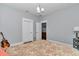 Comfortable bedroom with ensuite closet, light gray walls and hardwood floors at 12080 Se Sunset Harbor Rd, Weirsdale, FL 32195