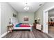 Relaxing bedroom featuring soothing colors, wood floors, comfortable bed, and stylish decor at 12080 Se Sunset Harbor Rd, Weirsdale, FL 32195