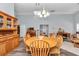 Open concept dining room with wood table set and stylish chandelier at 12080 Se Sunset Harbor Rd, Weirsdale, FL 32195