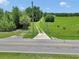 Picturesque driveway leading to a beautiful property, surrounded by greenery and a gated entrance at 12080 Se Sunset Harbor Rd, Weirsdale, FL 32195