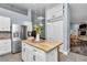 Open concept kitchen with island, stainless steel refrigerator, and easy access to dining and living areas at 12080 Se Sunset Harbor Rd, Weirsdale, FL 32195