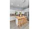 Bright kitchen features a butcher block island with seating, white cabinets and stainless steel appliances at 12080 Se Sunset Harbor Rd, Weirsdale, FL 32195