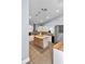 Bright open concept kitchen with butcher block counters, island with barstool seating and stainless appliances at 12080 Se Sunset Harbor Rd, Weirsdale, FL 32195