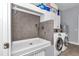 A functional laundry room featuring a dog wash station and modern appliances at 12080 Se Sunset Harbor Rd, Weirsdale, FL 32195